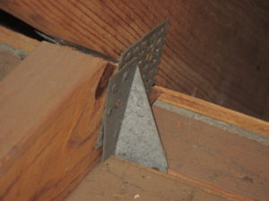 Inspection of a truss to wall connection in a building.